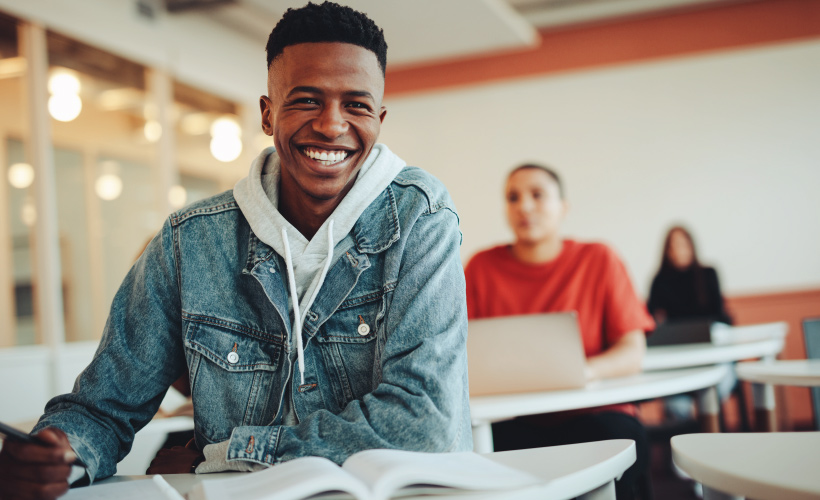 male African American student smiling in class